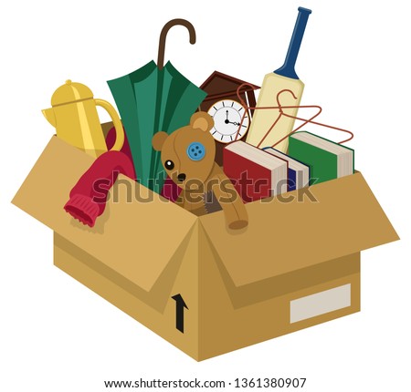 A cardboard box filled with various household junk items