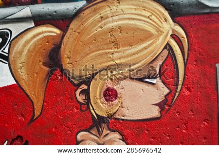 MULHOUSE - France - 08 June 2015 -  graffiti of blond woman during the BOZAR graffiti festival - quay of sinners in Mulhouse