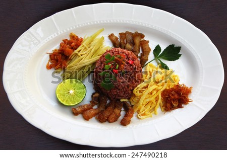 Thai style food. Shrimp paste fried rice . Famous  native Thai food fried rice with shrimp paste and compound with sour mango , sweet pork ,thin sheet egg, spicy with chili.