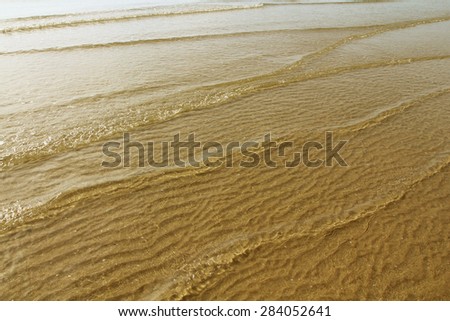 wave track on beach, sand texture, wave texture, wave pattern. gold beach.