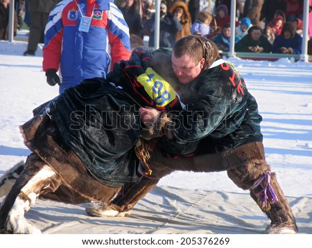 NADYM, RUSSIA - March 2, 2007: National Holiday - Day of the reindeer herders. The wrestling unknown men on holiday in Nadym, Russia - March 2, 2007.