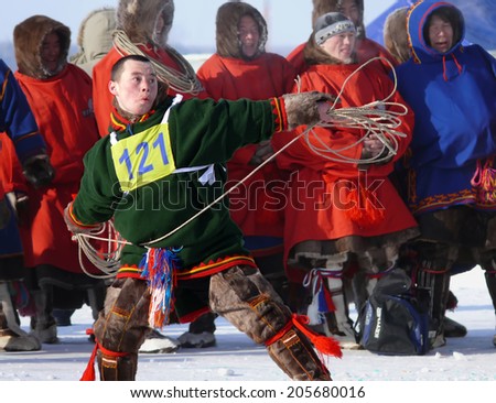 Nadym, Russia - March 15, 2008: the national holiday - the Day of the reindeer herder in Nadym, Russia - March 15, 2008. Sports competitions. Unknown man throws lasso.