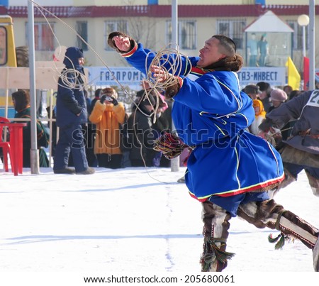 Nadym, Russia - on March 17, 2006: the national holiday - the Day of the reindeer herder in Nadym, Russia - on March 17, 2006. Sports competitions. Unknown man throws lasso.
