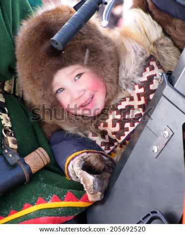 Nadym, Russia - March 11, 2005: the national holiday, the day of the reindeer herder in Nadym, Russia - March 11, 2005. Unknown boy Nenets on the snowmobile.