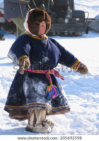 Nadym, Russia - March 2, 2007: the national holiday, the day of the reindeer herder in Nadym, Russia - March 2, 2007. Strangers Nenets boy standing on the street.