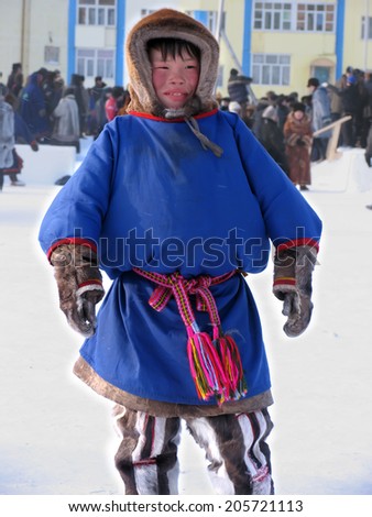 Nadym, Russia - March 11, 2005: the national holiday, the day of the reindeer herder in Nadym, Russia - March 11, 2005. Unfamiliar teen Nenets, stands in the center of the square.