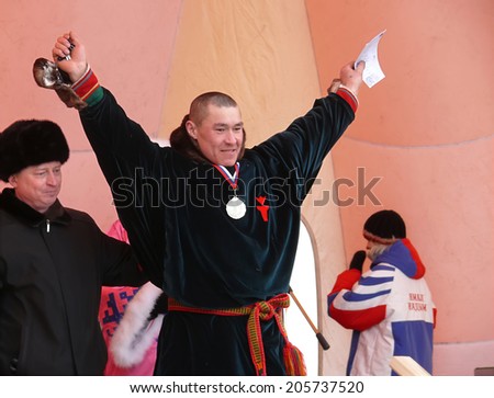 Nadym, Russia - March 16, 2008: the national holiday - the Day of the reindeer herder. The ceremony of awarding the winners. Unknown men, the winners of the competitions with diplomas on stage.
