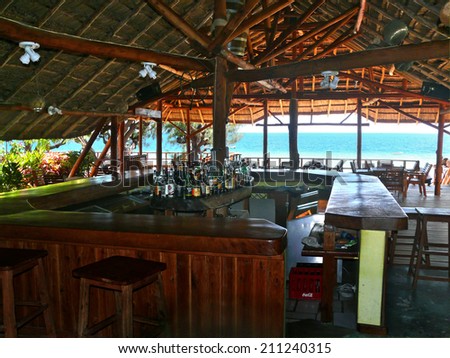 Inhassoro, Mozambique - December 9, 2008:  a Bar on the coast of the Indian ocean. The interior of the room. Bar with alcohol. The beach and the Indian ocean.