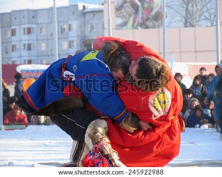 NADYM, RUSSIA - March 2, 2007: National Holiday - Day of the reindeer herders. The wrestling unknown men on holiday in Nadym, Russia - March 2, 2007.