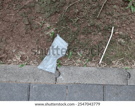 Similar – Image, Stock Photo Plastic straws thrown in ocean. Pollution concept. Flat lay on pink background