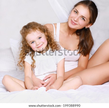Lovely beautiful mom and daughter in bed