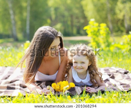 Happy mom and daughter having fun in summer day