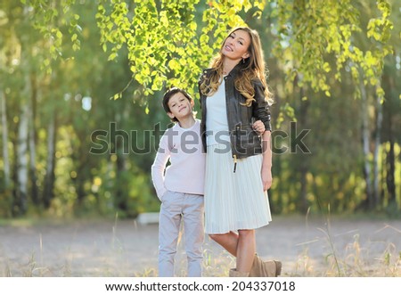 Mom and son walk in forest