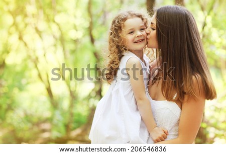 Happy mother kissing daughter