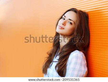 Beauty portrait pretty woman in the city summer near colorful wall