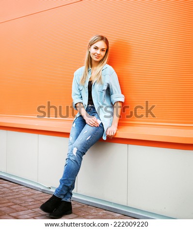 Cool girl posing against colorful wall, street fashion