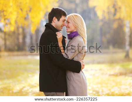 Autumn, love, relationships and people concept - lovely young pretty couple in sunny autumn day