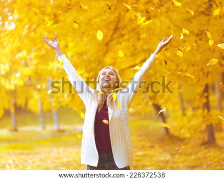 Leaf fall, colorful photo happy positive expression woman having fun in the autumn park
