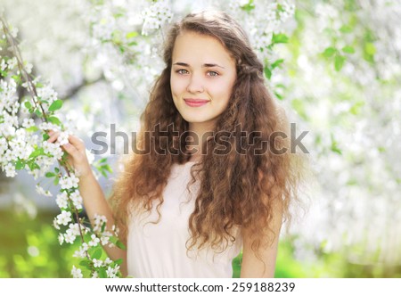 Portrait of cute girl in the spring flowering garden