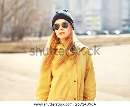 Fashion portrait of pretty hipster blonde girl outdoors in sunny day