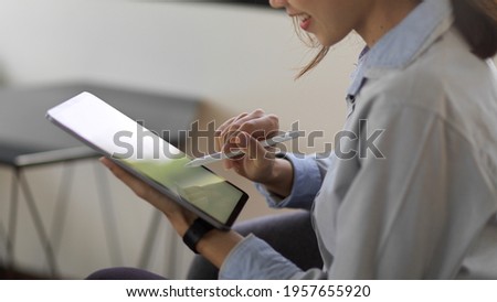 Similar – Image, Stock Photo Young businesswoman using digital tablet in her office