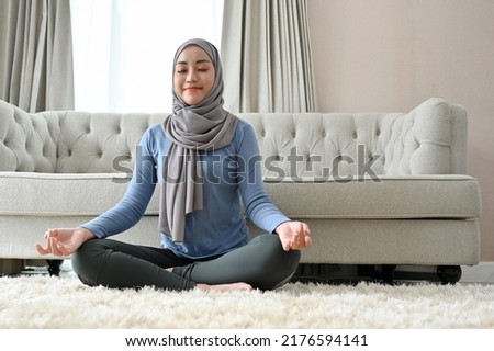 Similar – Image, Stock Photo Peaceful Arab woman doing yoga on embankment