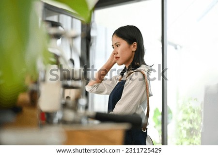 Similar – Image, Stock Photo Concentrated female cashier in face mask working with cash till