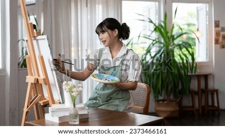 Similar – Image, Stock Photo Female artist painting on canvas in workshop