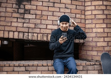 Similar – Foto Bild Entspannter männlicher Skater beim Musikhören in der Stadt