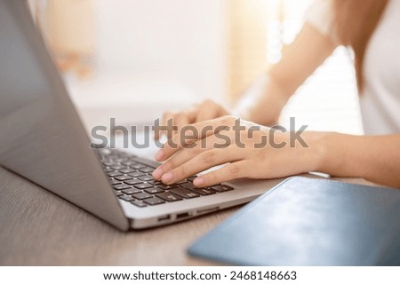 Similar – Image, Stock Photo Close up of female hands typing on laptop keyboard at home near his unrecognizable girlfriend. Business, working from home, studying online concept.