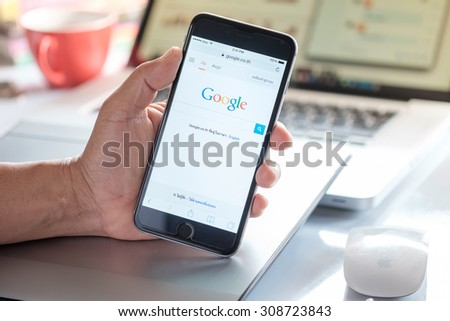 A man holding a iPhone 6 Space Gray with social networking service Google on the screen. iPhone 6 was created and developed by the Apple inc. CHIANG MAI, THAILAND: AUG 23,2015.