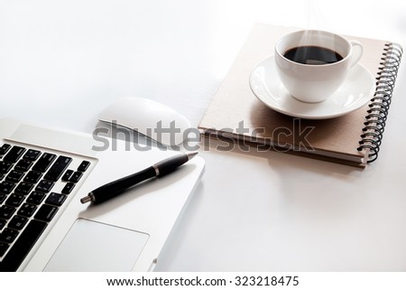 Cup of coffee and office supplies  on a white table background.