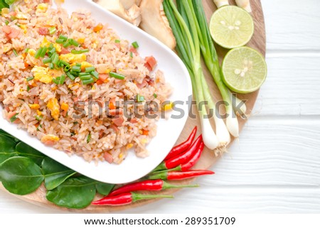 Thai Brown rice, fried eggs with ham and vegetables on the background of various kinds.