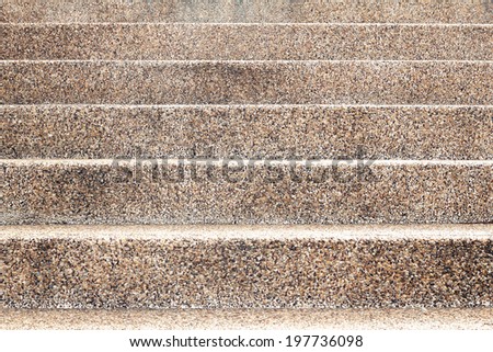 The abstract geometrical background formed by straight lines of a concrete ladder and a pebble wall