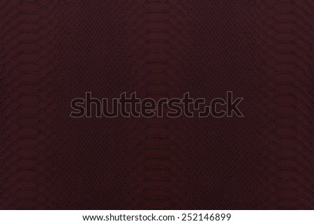 Texture background of red dark reptile leather