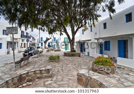 Mykonos street with external stairs of the houses and colorful balconies