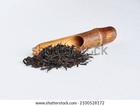 Oolong tea 'Da hong pao 大红袍, ' known under the  name 'Big red robe ' with wooden spoon on white  background close-up, copy space, side view. 商業照片 © 