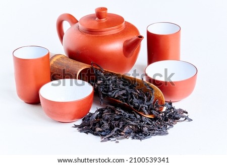Traditional сhinese teapot made of Yixing clay, oolong 'Da hong pao  大红袍' tea, known under original chinese name 'Big red robe', wooden spoon and tea cups  on white background , copy space. 商業照片 © 