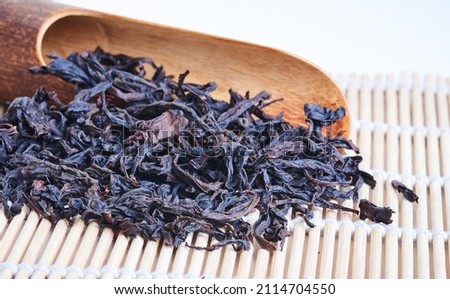Oolong tea 'Big red robe ' wildly known under original chinese name ' Da hong pao' 大红袍'  with wooden spoon on bamboo mat, side view, copy space. 商業照片 © 