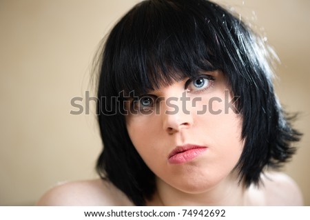 young plain looking woman with vivid blue eyes staring at the camera with narrow plain of focus