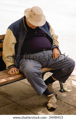 A heavy older gentleman who has fallen asleep on a city bench.