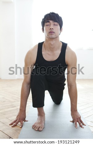 Korean man practicing yoga
