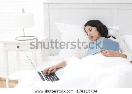 the image of Asian businesswoman and working at home in bed
