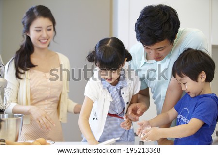 the image of a happy Asian family baking