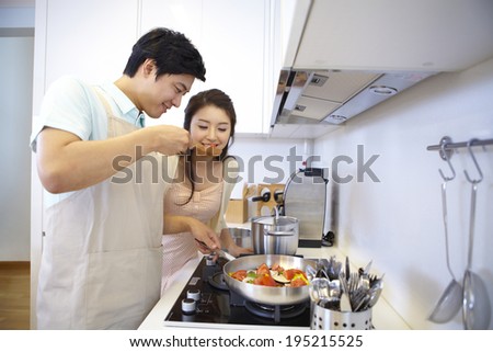 the image of a happy Asian family cooking