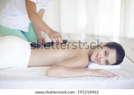 Asian woman having hot stone treatment