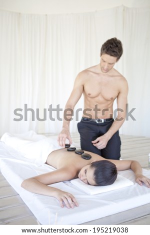 Asian woman having a massage treatment with hot stone