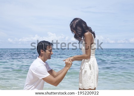 Man proposing to woman on the beach in the Philippines