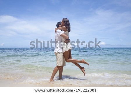 Asian couple hugging by the sea in Boracay in the Philippines