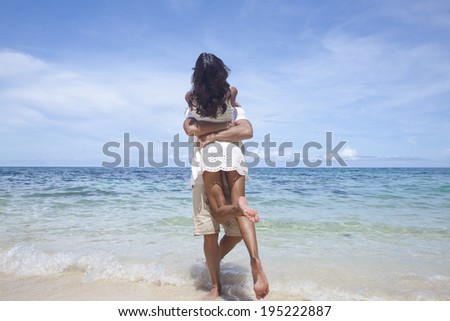 Asian couple hugging by the sea in Boracay in the Philippines